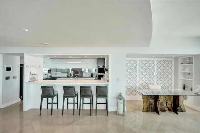 a dining room with furniture a potted plant and a chandelier