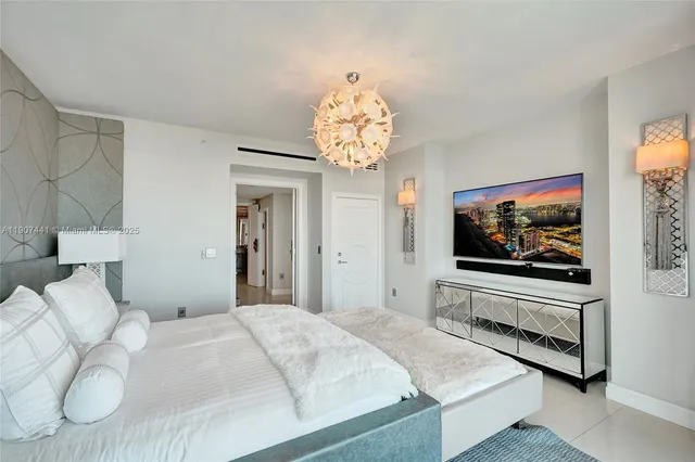 a bedroom with furniture and a large window