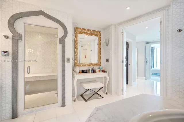 a bedroom with a bed and a lamp on dresser