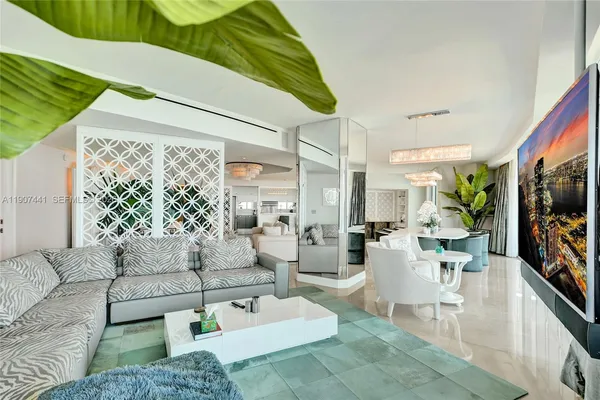 a living room with furniture and a painting on the wall