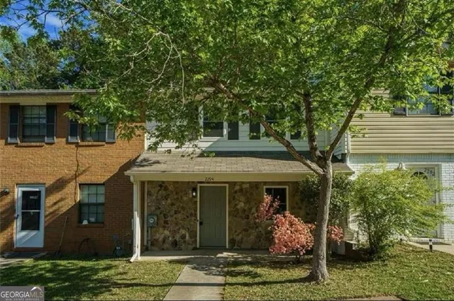 a front view of a house with garden