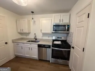 a kitchen with granite countertop a stove and a sink