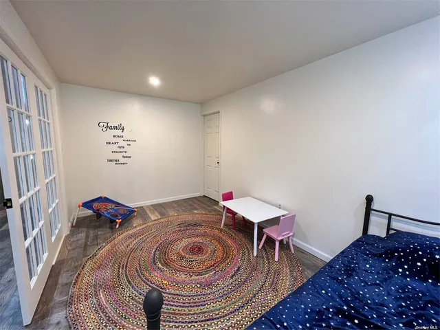 a bedroom with a bed and a dresser in it