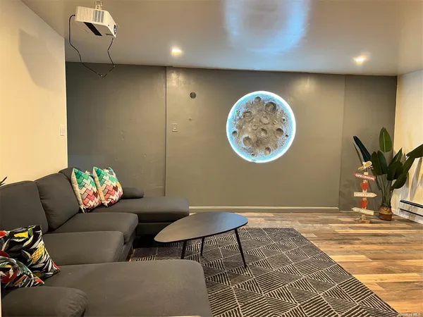 a living room with furniture and a white wall