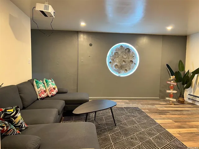 a living room with furniture and a white wall