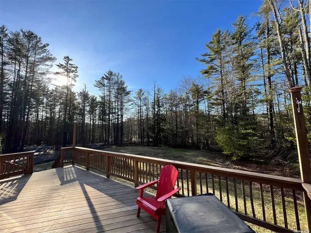 a view of a balcony with wooden floor and outdoor seating