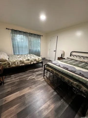 a bed room with furniture and window