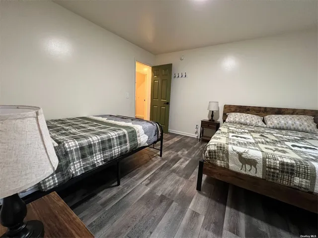 a bedroom with a bed next to a window
