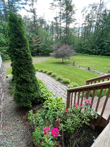 a view of a wooden deck with a garden