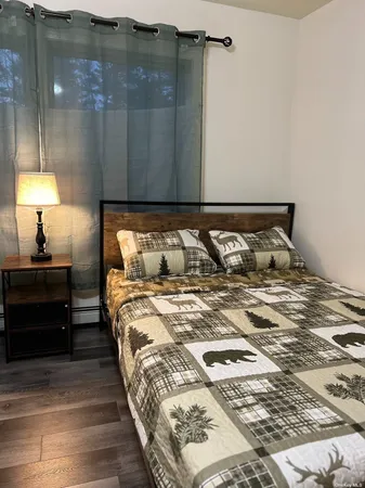a bedroom with a bed and a lamp