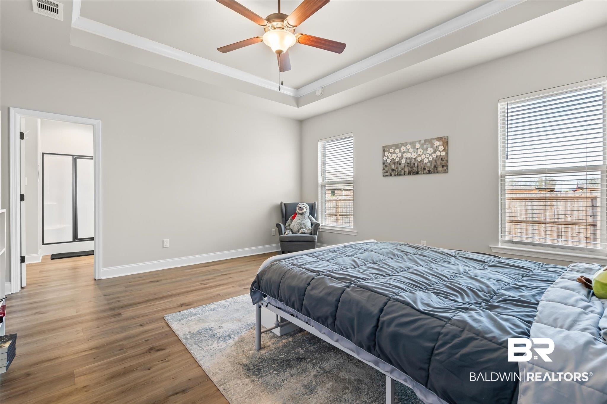 1116 Stella Road Foley, AL 36535 - Photo 13 of 29 Bedroom with dark wood-type flooring, a raised ceiling, ceiling fan, and ornamental molding
