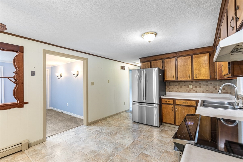 99 Swansom Road Swansea, MA 02777 - Photo 13 of 42 a kitchen with a refrigerator and a sink