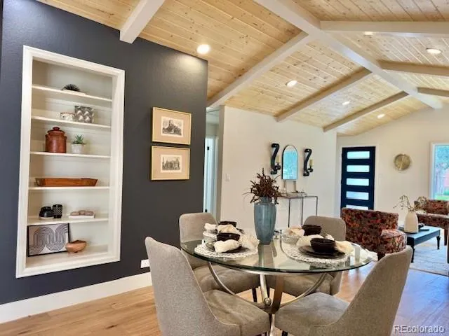 a dining room with furniture and wooden floor
