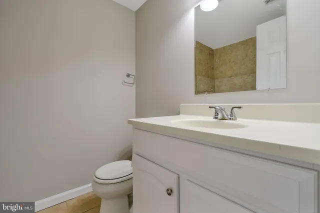 a bathroom with a sink toilet and a mirror