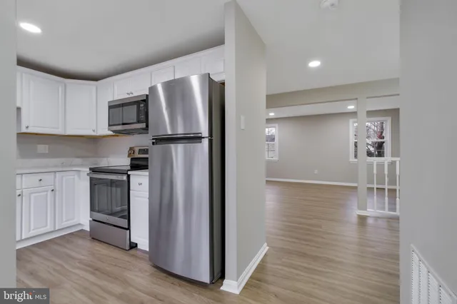a kitchen with stainless steel appliances granite countertop a refrigerator microwave and stove