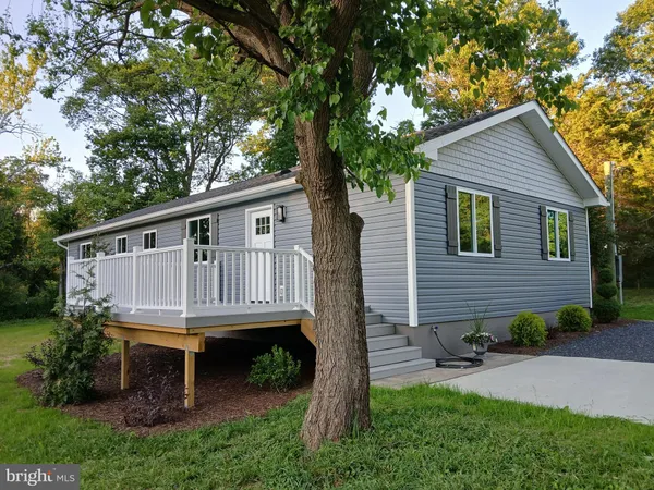 a backyard of a house with wooden deck and seating space