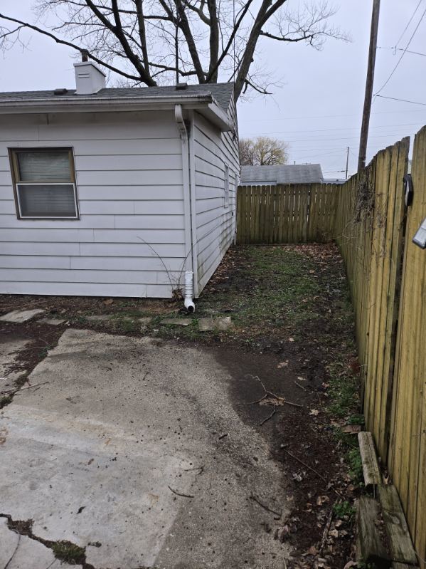 1505 West Columbia Avenue Champaign, IL 61821 - Photo 6 of 8 a view of a house with a small yard and wooden fence