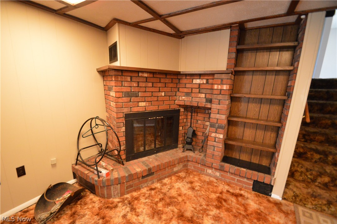 525 Howland Wilson Road Northeast Warren, OH 44484 - Photo 15 of 26 Custom Brick fireplace with built in book shelf (lower level family room)