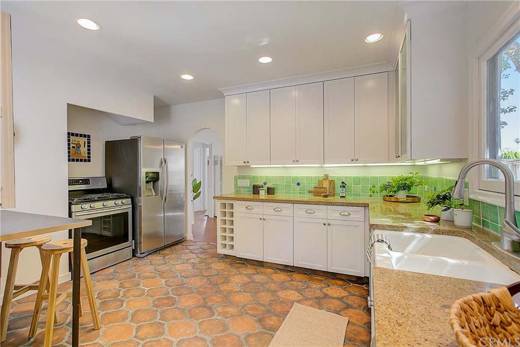 1126 Scofield Drive Glendale, CA 91205 - Photo 13 of 49 a large kitchen with kitchen island a sink stainless steel appliances and cabinets