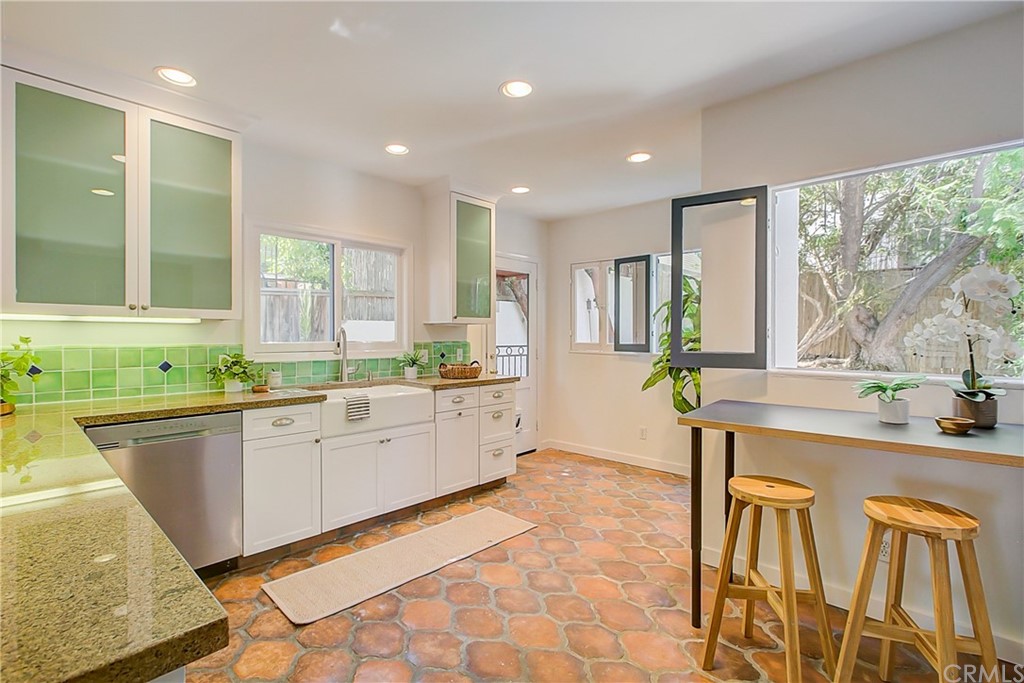 1126 Scofield Drive Glendale, CA 91205 - Photo 14 of 49 a large kitchen with kitchen island granite countertop a sink and cabinets