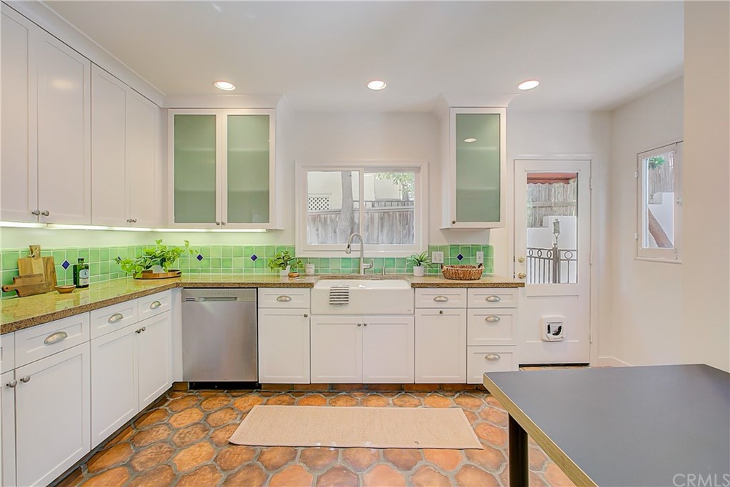 1126 Scofield Drive Glendale, CA 91205 - Photo 17 of 49 a large kitchen with granite countertop white cabinets and white appliances