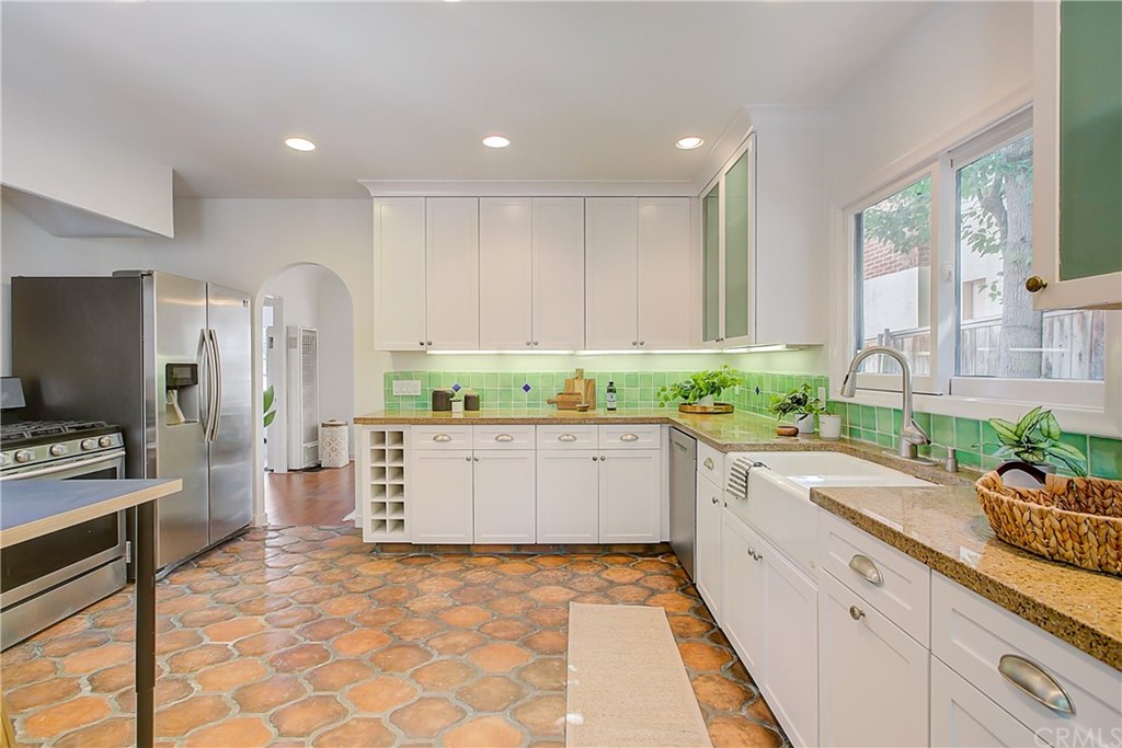 1126 Scofield Drive Glendale, CA 91205 - Photo 18 of 49 a large white kitchen with stainless steel appliances granite countertop a stove a sink and a refrigerator