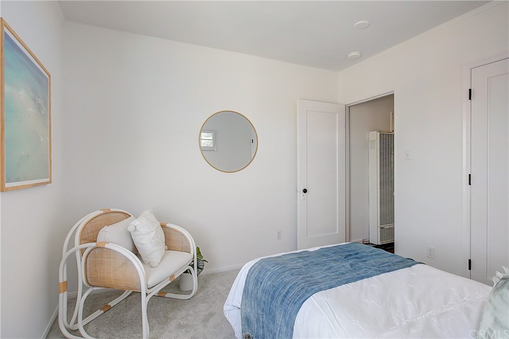 1126 Scofield Drive Glendale, CA 91205 - Photo 20 of 49 a bedroom with a bed a mirror and a chair
