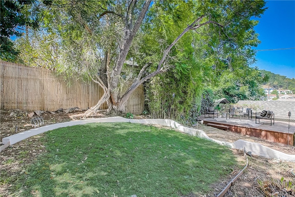 1126 Scofield Drive Glendale, CA 91205 - Photo 28 of 49 a view of a backyard with table and chairs and a large tree