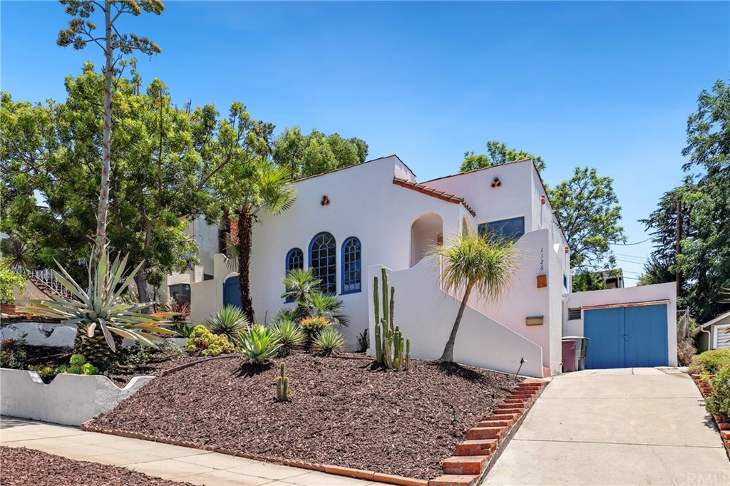 1126 Scofield Drive Glendale, CA 91205 - Photo 3 of 49 a white house with a yard and plants