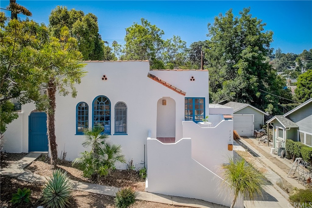 1126 Scofield Drive Glendale, CA 91205 - Photo 38 of 49 a view of a white house with large trees and plants