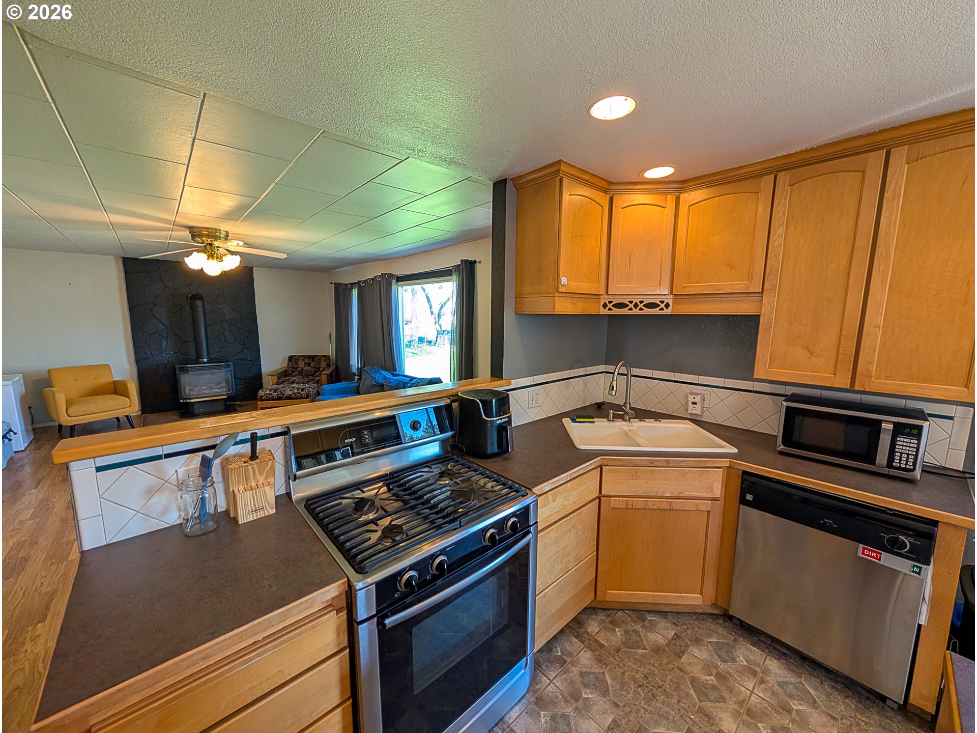 2802 North Spruce Street La Grande, OR 97850 - Photo 5 of 26 a kitchen that has a sink stainless steel appliances and cabinets