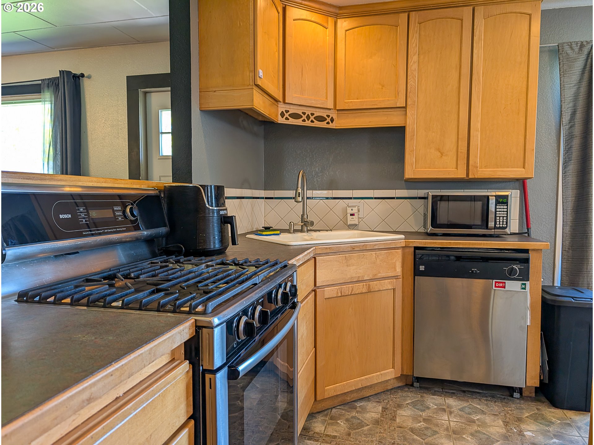 2802 North Spruce Street La Grande, OR 97850 - Photo 6 of 26 a kitchen with a stove and a microwave