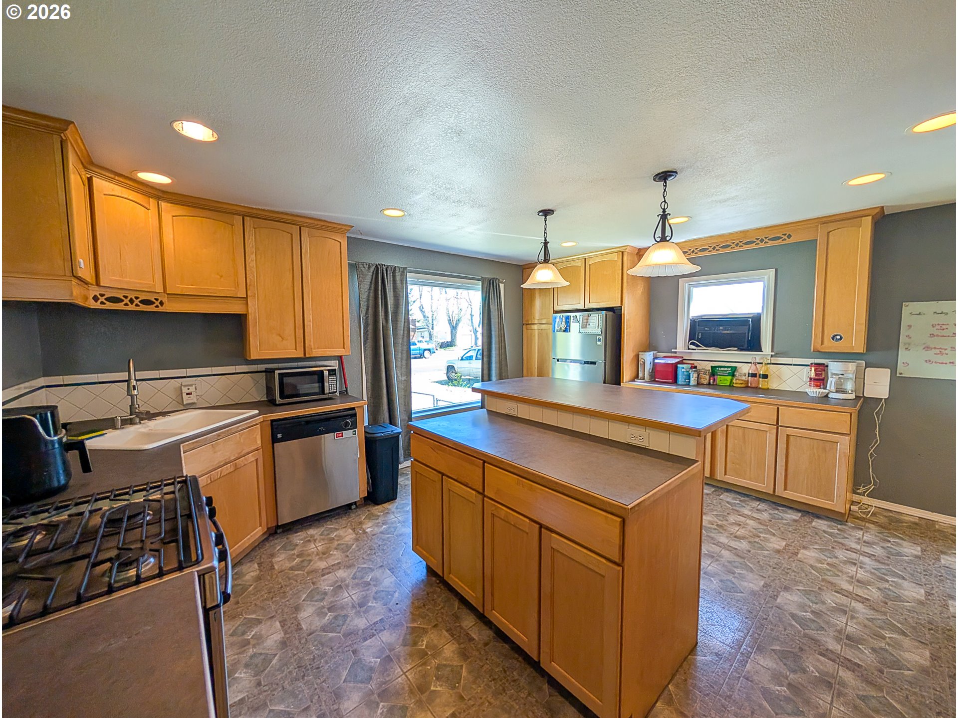 2802 North Spruce Street La Grande, OR 97850 - Photo 7 of 26 a kitchen with kitchen island granite countertop a stove and a sink