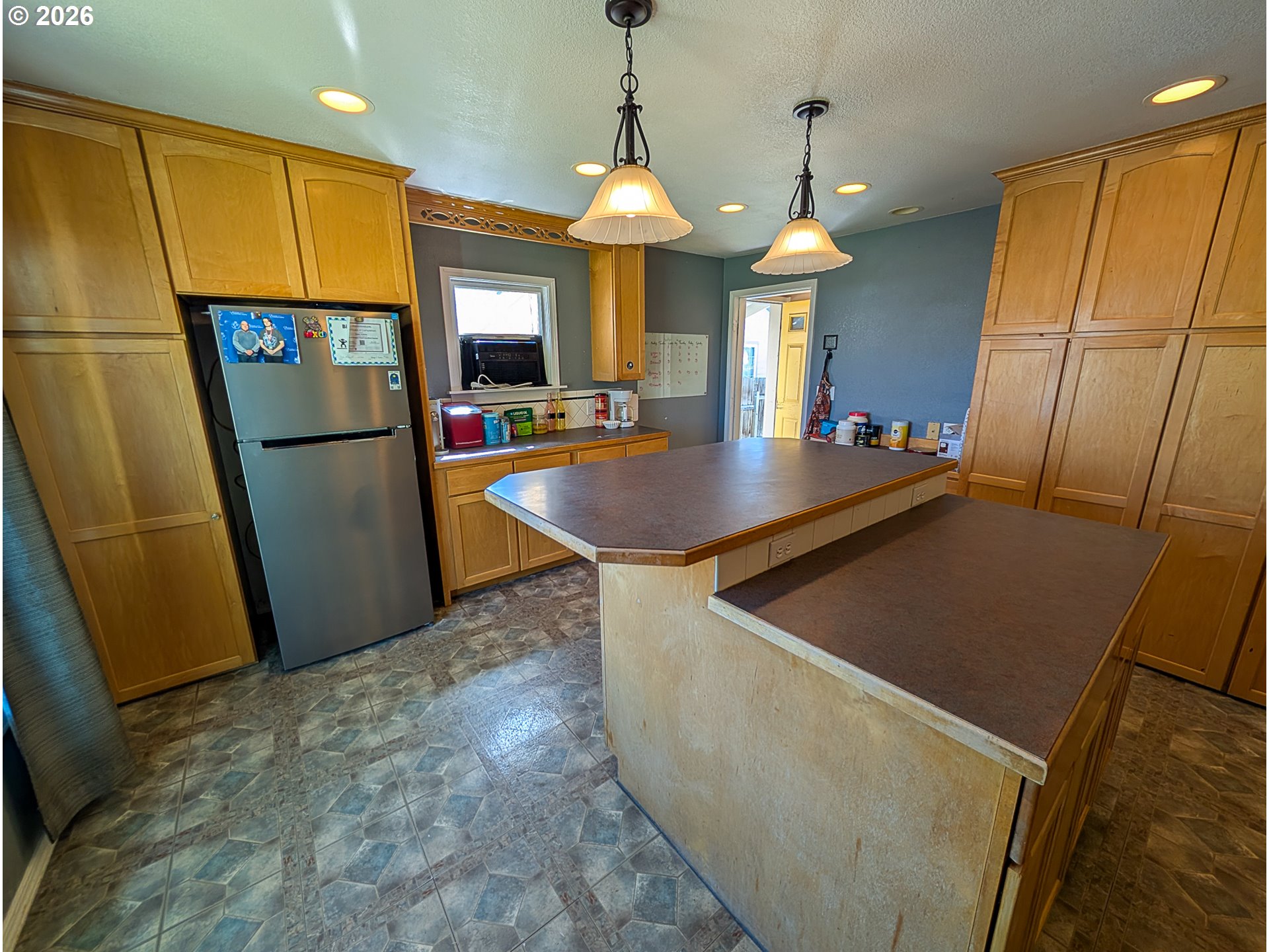 2802 North Spruce Street La Grande, OR 97850 - Photo 8 of 26 a kitchen with stainless steel appliances granite countertop a refrigerator a sink a stove and a refrigerator
