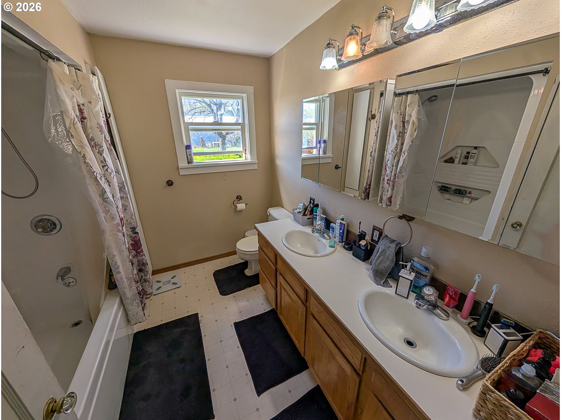 2802 North Spruce Street La Grande, OR 97850 - Photo 10 of 26 a bathroom with a sink a toilet a mirror a vanity and shower