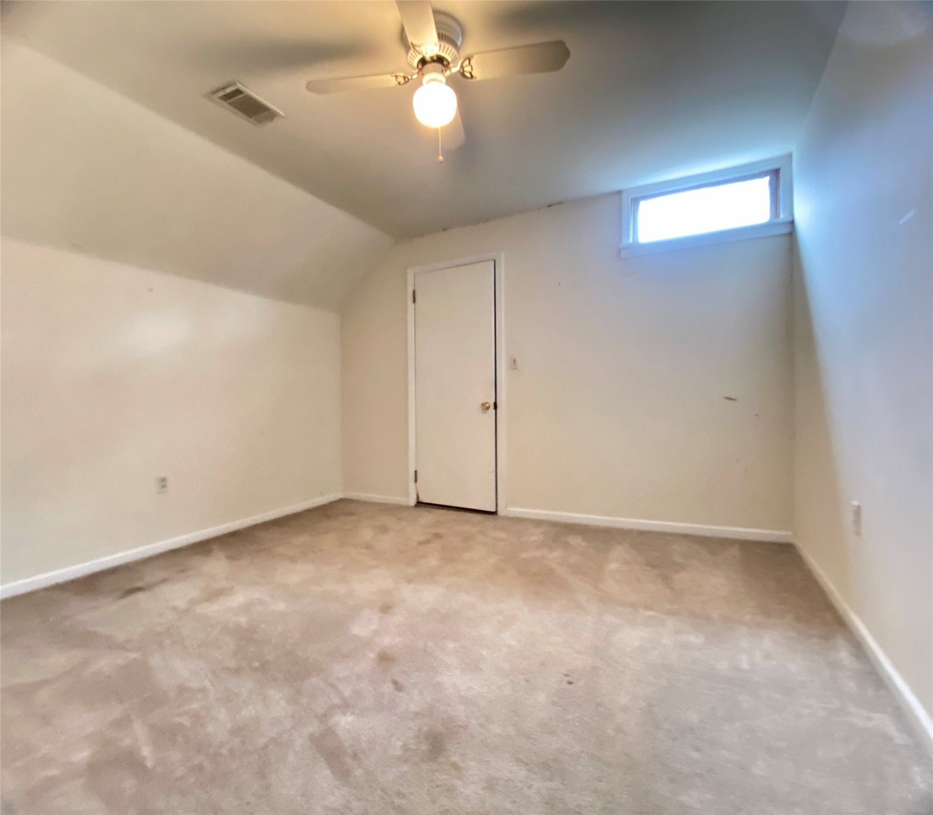 223 East Robert Toombs Avenue Washington, GA 30673 - Photo 38 of 46 an empty room with a chandelier fan and windows