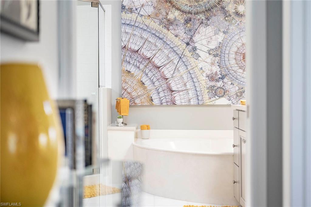 6533 Ilex Circle Naples, FL 34109 - Photo 11 of 34 a bathroom with a bathtub and a shower