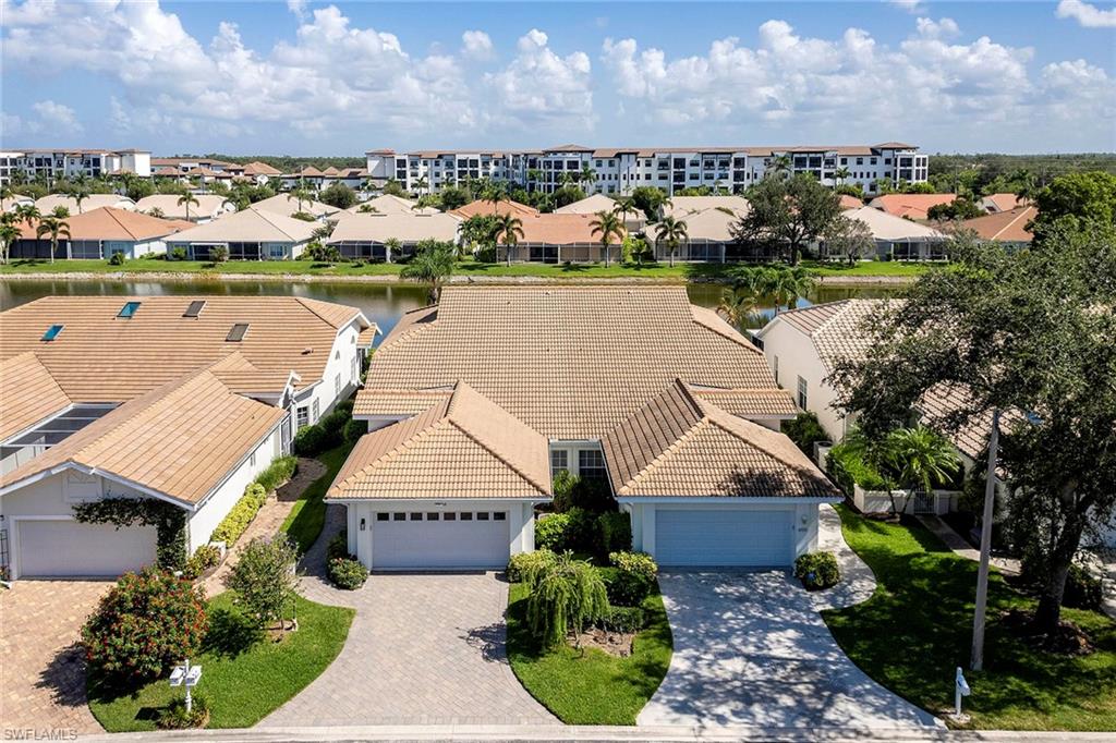 6533 Ilex Circle Naples, FL 34109 - Photo 16 of 34 an aerial view of a house with a lake view