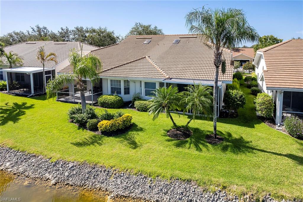 6533 Ilex Circle Naples, FL 34109 - Photo 17 of 34 a view of house with garden and tall tress