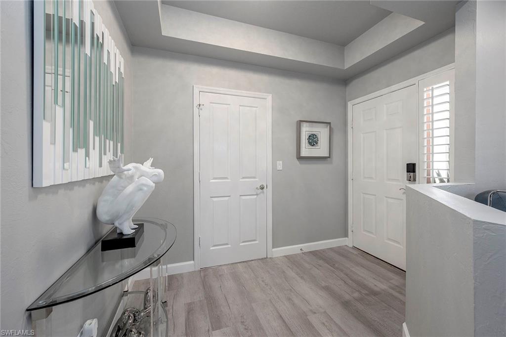6533 Ilex Circle Naples, FL 34109 - Photo 18 of 34 a room that has a window and wooden floor