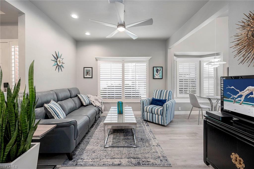 6533 Ilex Circle Naples, FL 34109 - Photo 19 of 34 a living room with furniture and a flat screen tv