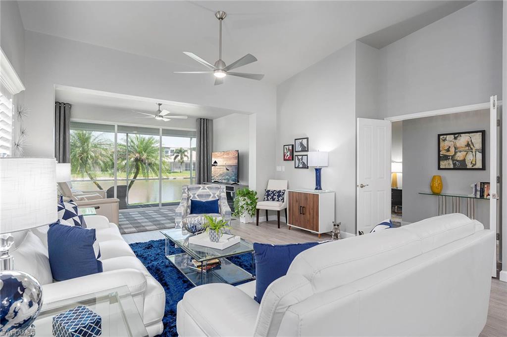 6533 Ilex Circle Naples, FL 34109 - Photo 25 of 34 a living room with furniture and a large window