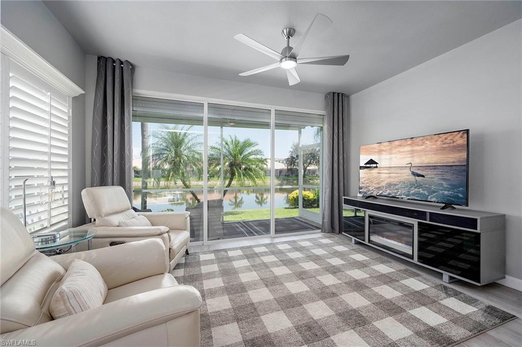 6533 Ilex Circle Naples, FL 34109 - Photo 26 of 34 a living room with furniture and a flat screen tv