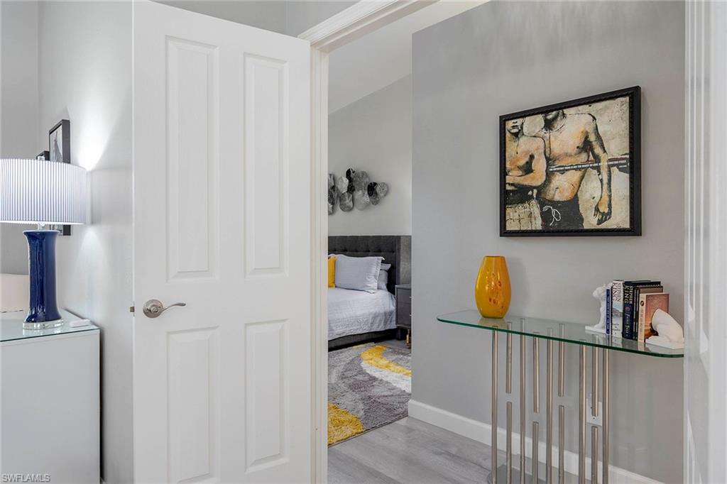 6533 Ilex Circle Naples, FL 34109 - Photo 27 of 34 a bedroom with a bed and a painting on the wall