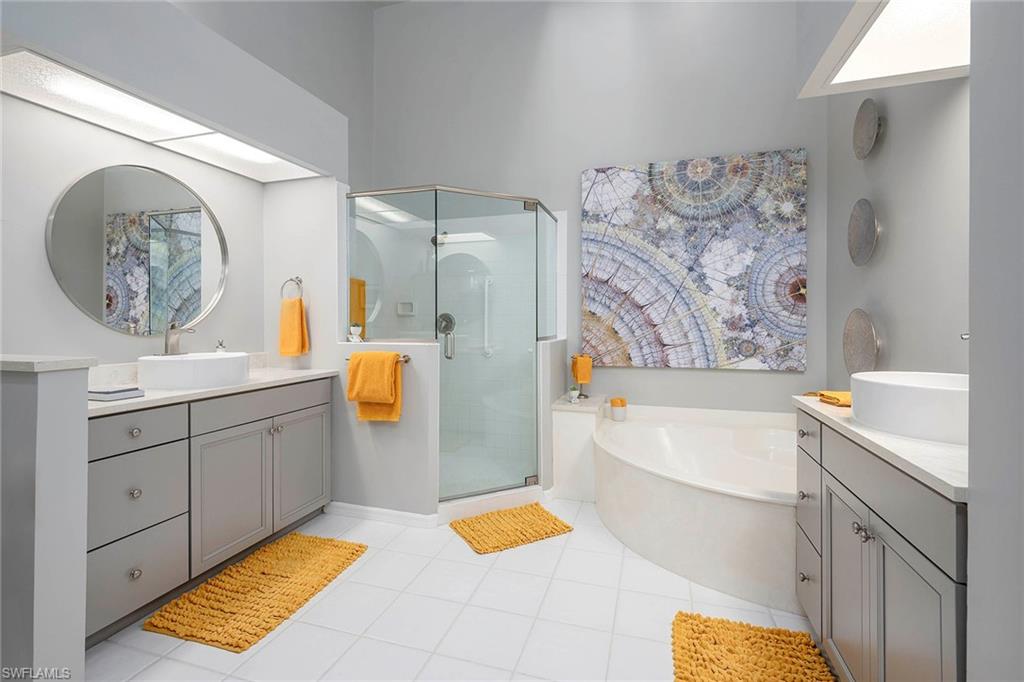 6533 Ilex Circle Naples, FL 34109 - Photo 30 of 34 a bathroom with a bathtub and a sink
