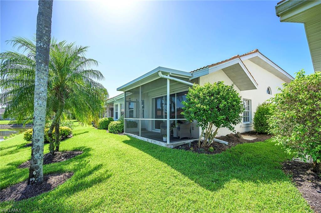 6533 Ilex Circle Naples, FL 34109 - Photo 3 of 34 a view of a backyard with potted plants and a large tree