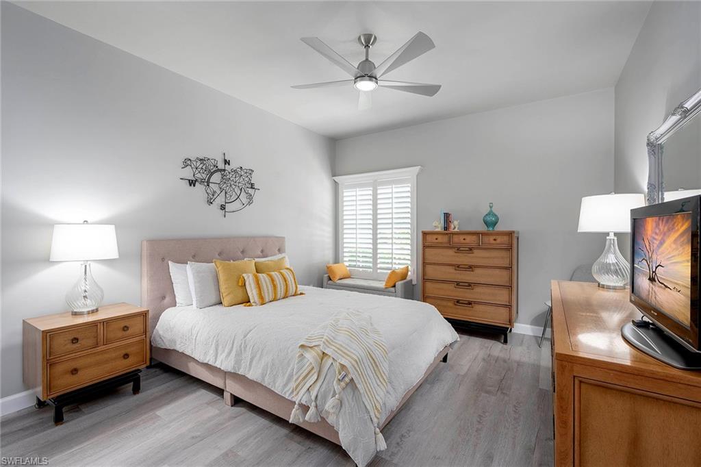 6533 Ilex Circle Naples, FL 34109 - Photo 31 of 34 a bedroom with a bed and a tv