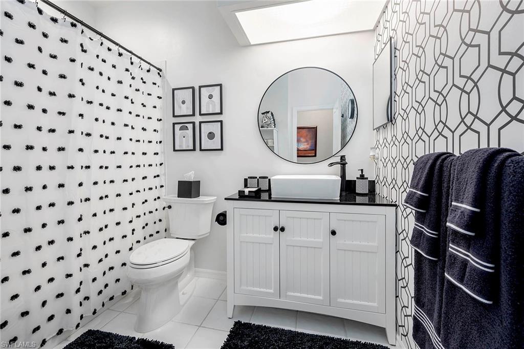 6533 Ilex Circle Naples, FL 34109 - Photo 32 of 34 a bathroom with a sink toilet and mirror
