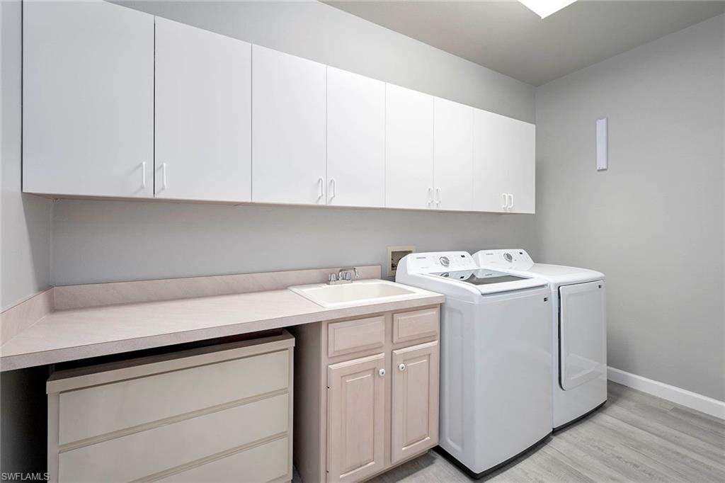 6533 Ilex Circle Naples, FL 34109 - Photo 33 of 34 a utility room with dryer and washer