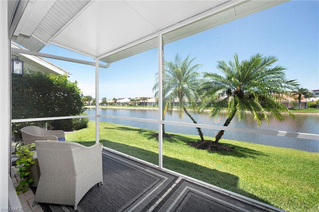 6533 Ilex Circle Naples, FL 34109 - Photo 34 of 34 a view of a swimming pool with a chair and floor to ceiling window